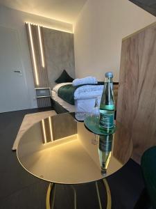 a room with a table with a bottle on it at Lilium Resort Hotel & Restaurant in Bad Rodach