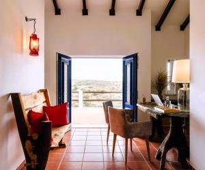 una sala da pranzo con tavolo e sedie e vista di Monte do Alento - Castro da Cola a Alcaria