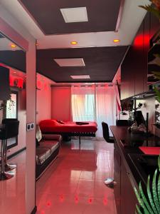 a red living room with a couch and a bed at 12 Phantasm in Cap d'Agde