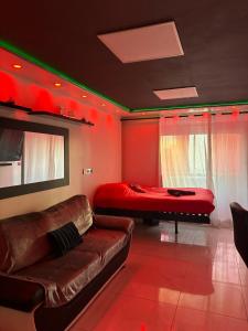 a living room with a couch and a bed at C12 Deluxe in Cap d'Agde +37 photos