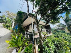 a house on the side of a road with plants at Cabin de Paulin 1 in Tagaytay