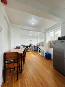 a living room with a table and a kitchen at Cabin de Paulin 1 in Tagaytay +18 photos