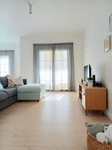 a living room with a couch and a table at Ericeira Vibes in Ericeira