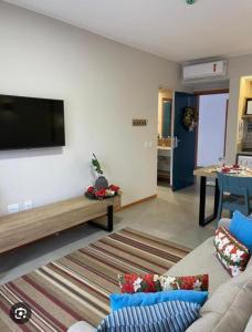 a living room with a couch and a flat screen tv at Quinta Santa Bárbara eco resort in Pirenópolis