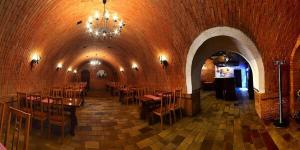 a restaurant with tables and chairs in a tunnel at Penzion Miluška in Břeclav