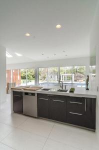 a large kitchen with a sink and a counter at West Hamptons Zen retreat in Westhampton