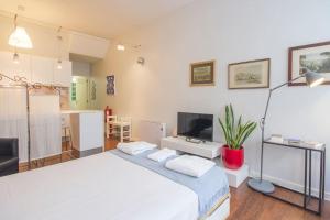 una camera con letto bianco e TV di OHH - Ganesha studio- Oporto Center a Porto