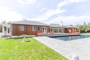 a house with a swimming pool in front of it at West Hamptons Zen retreat in Westhampton