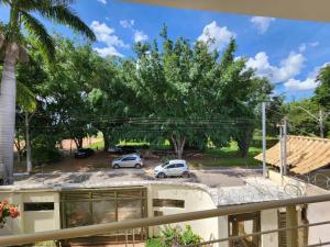 a view from the balcony of a house with cars in a parking lot at Residencial Oliveiras - Apartamento 3 in Brasilia