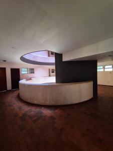 a room with a large bed in a building at Flat Central do Martins in São Luís