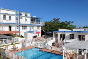 a large white house with a swimming pool in front of it at Humacao Villa - 8BR, Pool, Palmas, Ocean Views 