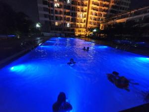 a pool with people swimming in it at night at The Wonder Bay Halong studio in Ha Long