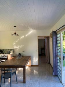 a dining room with a wooden table in a room at Rotui Lodge in Paopao