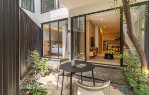 an internal courtyard of a house with a table and chairs at Casa Calderón by Kukun in Mexico City