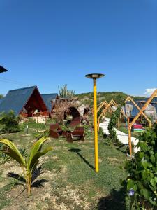 a playground with a yellow pole in a park at Hotel Luna Azul Tatacoa in Villavieja