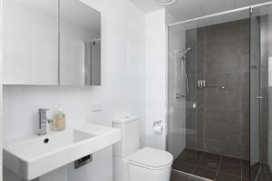 a bathroom with a toilet and a sink and a shower at Nalu in Newcastle +4 photos