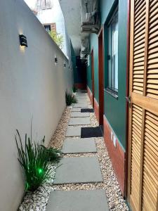 a narrow alley with a building and a door at Morada do Sol Suítes in Arraial do Cabo
