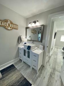 a bathroom with a sink and a mirror at Sandy Haven in Bolivar Peninsula +28 photos
