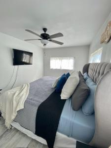 a bedroom with a bed and a ceiling fan at Sandy Haven in Bolivar Peninsula
