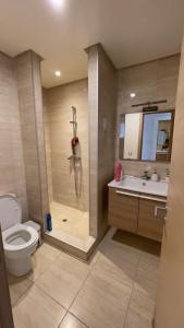 a bathroom with a shower and a toilet and a sink at Appartement Prestigia des nations in Salé