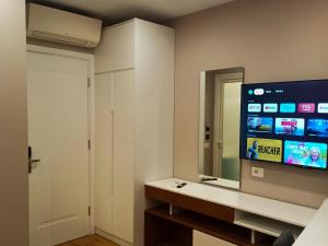 a room with a mirror and a tv in a room at Star Hotel in Tirana +51 photos