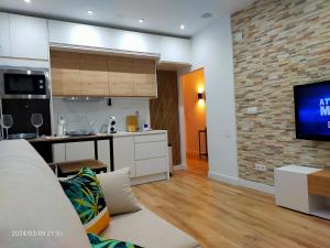 a living room with a couch and a kitchen at El Pardo in Haro