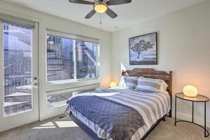 a bedroom with a bed and a large window at Golden Rooftop w Mountain Views - Walk to DT Golden School of Mines Close to Red Rocks in Golden