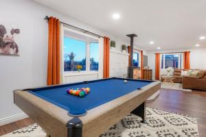 a pool table in the middle of a living room at One of a Kind Home with HOT TUB Pool Table and Fire Pit 4 Miles to DT in Denver