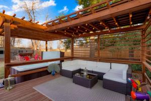 an outdoor patio with a pergola and a couch at Best Experience in Denver HOT TUB and FIRE PIT 4 miles to DT in Denver