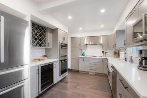 a kitchen with white cabinets and white counter tops at Best Experience in Denver HOT TUB and FIRE PIT 4 miles to DT in Denver