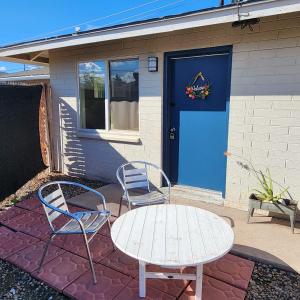 a table and two chairs and a blue door at *Msg for 5%off*2Bed1Bath KingQueenBeds MidtownPHX in Phoenix