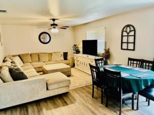 a living room with a couch and a table with chairs at Lighthouse Suite Pet Friendly Hot Tub Sleeps 4 in Coarsegold