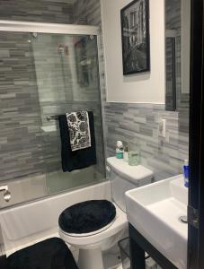 a bathroom with a toilet and a shower and a sink at Sunny room on Manhattan’s Upper west side in New York