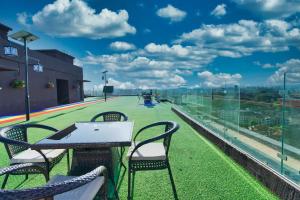 a table and chairs on the roof of a building at Spacious, beautiful, elegant, with natural light 1 bedroom Apartment in Nairobi