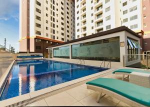a large swimming pool in a building with buildings at Spacious, beautiful, elegant, with natural light 1 bedroom Apartment in Nairobi