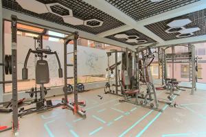 a gym with several treadmills and machines at Spacious, beautiful, elegant, with natural light 1 bedroom Apartment in Nairobi