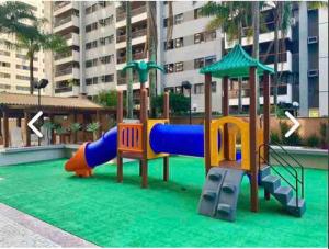 a playground with a slide in a building at Ap na Barra da Tijuca, atrás do Windsor in Rio de Janeiro