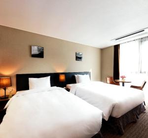 Postel nebo postele na pokoji v ubytování Hotel K-Tree Pyeongtaek