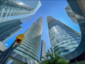 two tall buildings in a city with a blue sky at Presidential Suite Heart of Downtown with Stunning View in Toronto