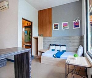 a bedroom with a bed and a desk in it at RedDoorz at Anton's Loft Designer Resort Pansol Calamba Laguna in Laguna +8 photos
