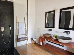 a bathroom with a sink and a toilet at Vandalous Bay in Pasikuda