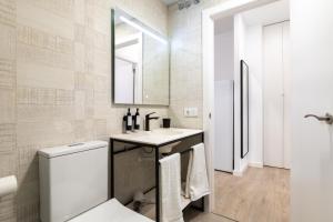 uma casa de banho com um lavatório, um WC e um espelho. em Moontels Plaza de Vannes em Valência