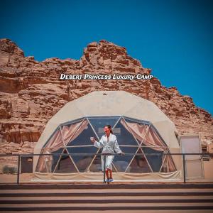 a woman standing in front of a dome tent at desert princess luxury camp in Wadi Rum