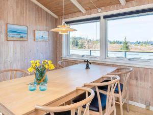 - une salle à manger avec une table et des chaises en bois dans l'établissement Holiday home Thisted LX, à Thisted