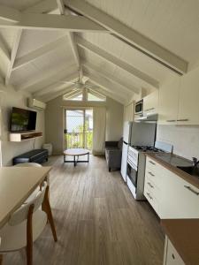 a large kitchen and living room with a large window at Shelly Beach Holiday Park in The Entrance