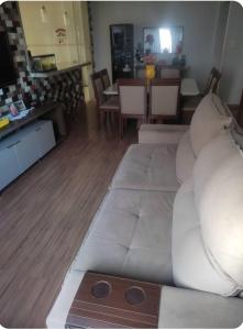 a living room with a white couch and a table at Casa da cylla in Alto Caparao