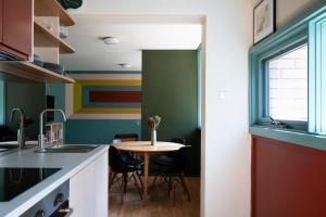 a kitchen with a table and a colorful wall at Sun filled 1BR APT 2 mins to Legacy Park in Campbell