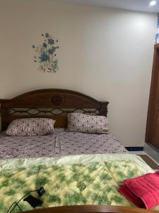 a bedroom with a bed with two pillows on it at Murree Oaks Tulip Block in Murree