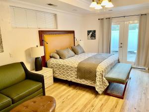 a bedroom with a bed and a chair and a couch at Peacock House Sleeps 12 Hot Tub Game Room in Ahwahnee