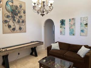 a living room with a couch and a table at Peacock House Sleeps 12 Hot Tub Game Room in Ahwahnee